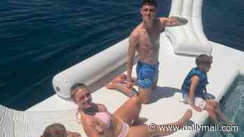 Phil Foden and his girlfriend Rebecca Cooke look loved-up as they enjoy the watersports on family holiday - after World Cup snub