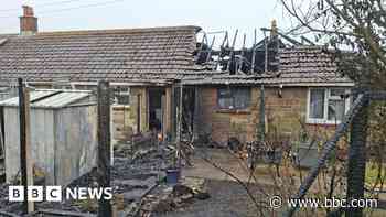 Woman suffers burns after roof fire at bungalows