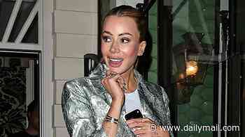 Olivia Attwood accessorises her mini skirt with her favourite £26k designer bag and fun, feathered heels as she joins Nicky Hilton at charity fashion dinner