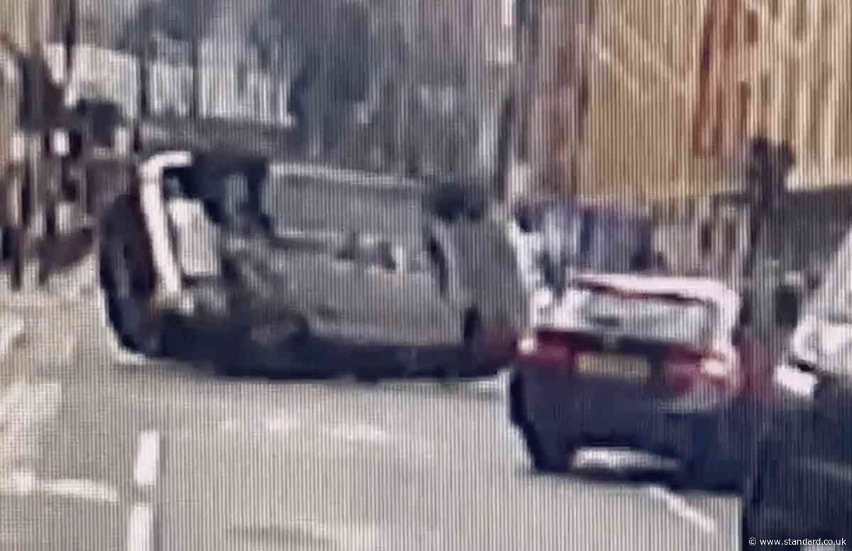 Moment police car flips onto side during central London chase