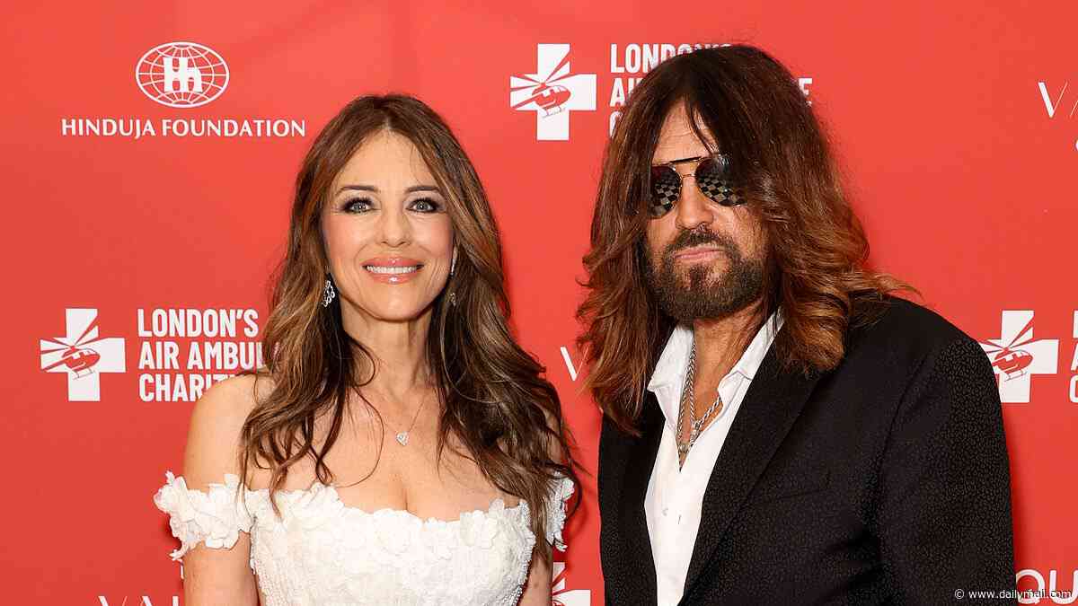 Elizabeth Hurley wows in bridal-esque figure-hugging white dress as she appears hand in hand with boyfriend Billy Ray Cyrus at London's Air Ambulance Charity gala