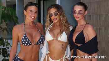 Arabella Chi shows off her toned figure in a white crochet cut-out dress as she parties with bikini-clad Chloe Ferry and Angel Swift on SHEIN's Ibiza trip