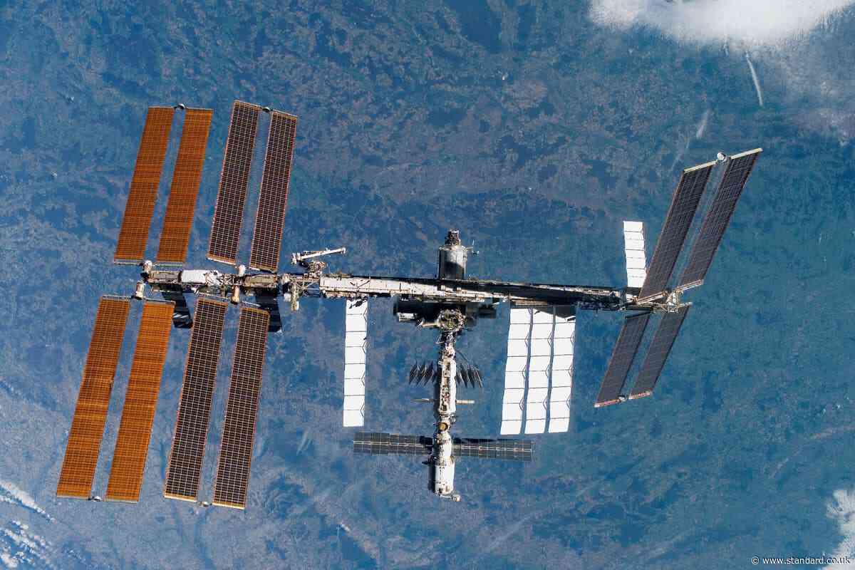 Space station astronauts stood ready to evacuate during air leak repairs