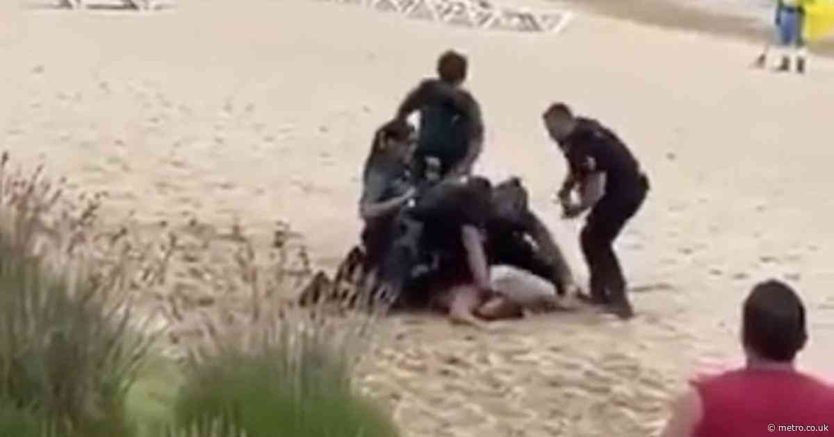 Tourist beaten by police after trying to shadowbox them naked