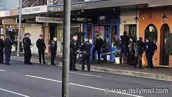 Police swarm to Bondi: Road is closed and man is rushed to hospital as a dozen officers race to scene