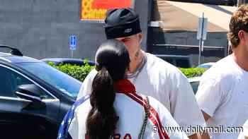 Romeo Beckham kisses girlfriend Kim Turnbull as they surprise fans at LA pop up launch of his new clothing line
