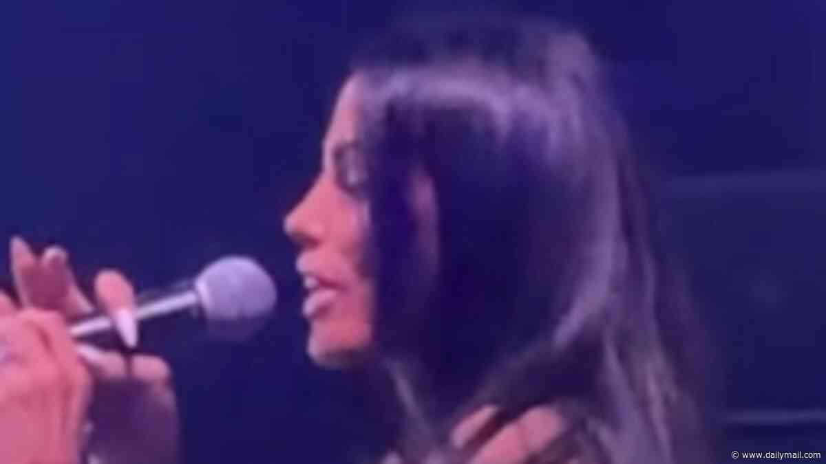 Katie Price enjoys a wild night out as she vapes and sings on stage before asking crowd if she should divorce her incarcerated husband Lee Andrews after putting her wedding ring back on