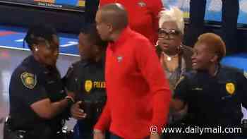 Enraged WNBA coach has to be escorted off the court by three police officers after he exploded at referee