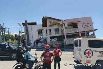 A 7.8 magnitude quake in the Philippines kills at least 19, fells buildings and sets off a tsunami