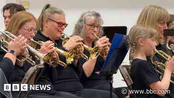 Brass band plays after being saved from collapse