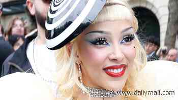 Doja Cat shocks as she flashes her thong in an outlandish inflatable sheer dress with faux nipple piercings as she attends MAC event in Paris