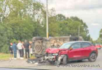 Overturned vehicle blocks A2 after crash at roundabout