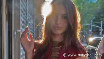 Emily Ratajkowski smokes a cigarette as she goes braless in a daring cut-out red dress while celebrating at her 35th birthday party