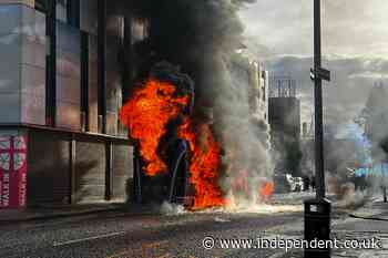 Belfast stabbing latest: Protesters set bus on fire as man charged with attempted murder after knife attack