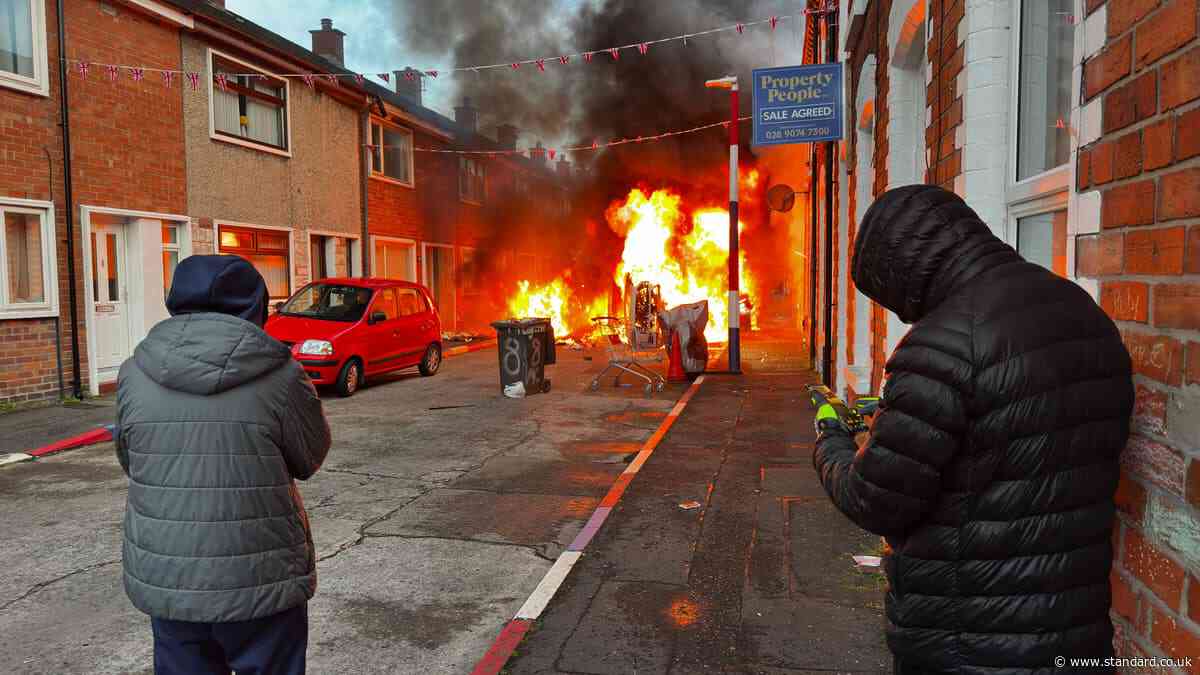 Residents evacuate as Belfast protesters set homes and vehicles on fire as disorder erupts after knife attack