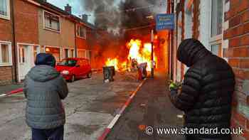 Residents evacuate as Belfast protesters set homes and vehicles on fire as disorder erupts after knife attack
