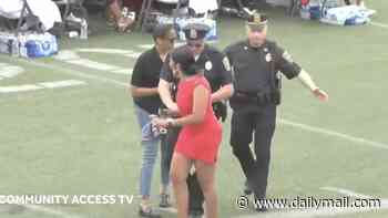Mom wearing red minidress is carted off during high school graduation ceremony after heckling at mayor for 'wrongdoing with her daughter'