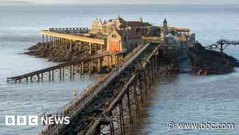 New section of historic pier lifted into place