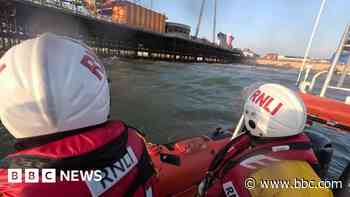 RNLI tries to find family saved from sea after clinging to pier
