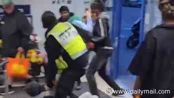 Moment gang of thugs brawl with security guard inside north London Lidl supermarket