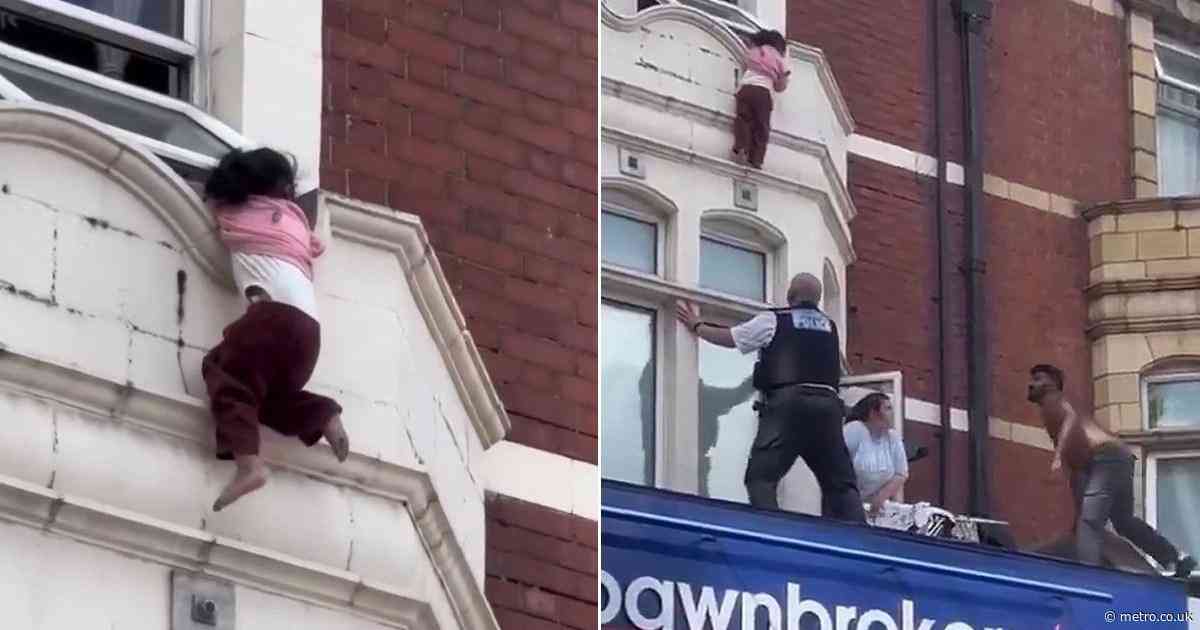 Toddler dangles from window ledge before dramatic rescue above shop in Ilford