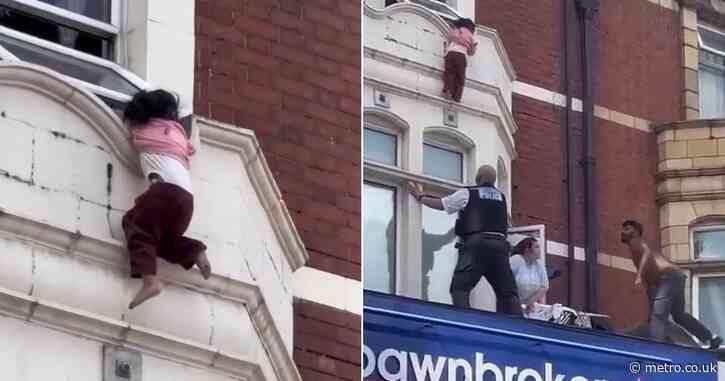 Young girl dangles from window ledge before dramatic rescue above shop in Ilford