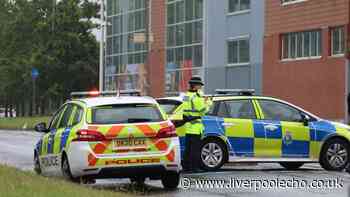 Man on Tesco roof live as West Derby road closed