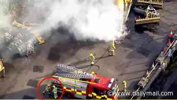 Moment two firefighters fight with each other as their colleagues battle lorry blaze during Belfast riots