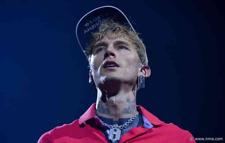 Watch MGK “mess my back up really, really bad” as he somersaults off roof into audience