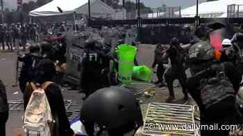 Chaos erupts outside Mexico City World Cup stadium as protesters fight with riot police and man suffers heart attack