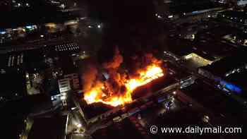 Huge fire erupts at London warehouse as residents are evacuated from their homes and 150 firefighters rush to tackle blaze