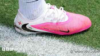 Why are footballers wearing pink boots at the World Cup?