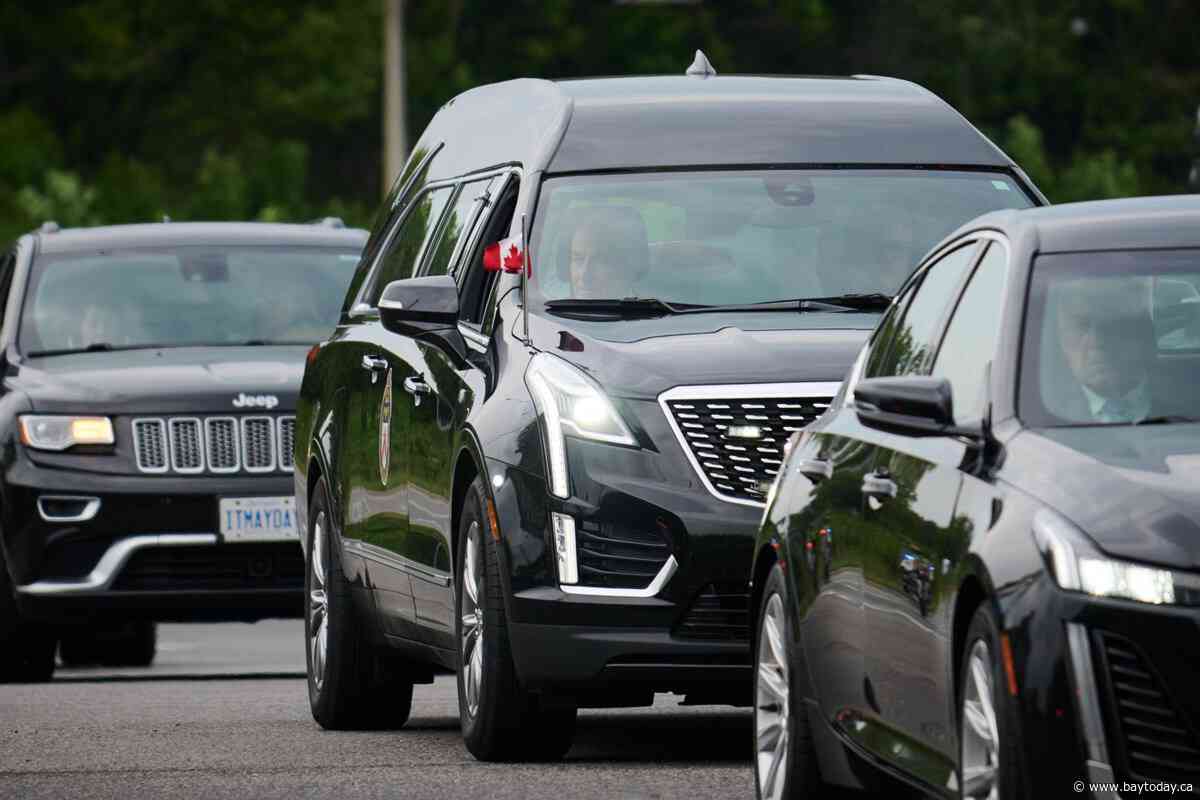 Tributes pour in for slain Toronto constable as suspect remains at large