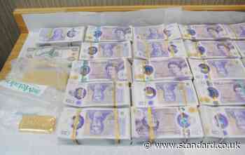 Moment police raid east London money store as they seize £2.5 million in cash and gold