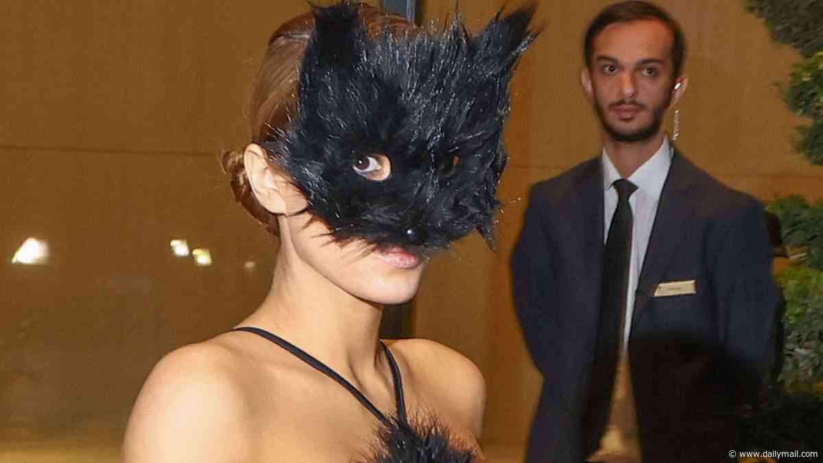 Naughty kitty! Kanye's wife Bianca Censori is bra and underwear free in a VERY sheer gown with a CAT mask