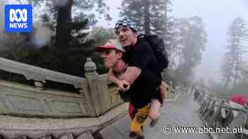 They know it looks unusual, but these mates are 'piggybacking the world'
