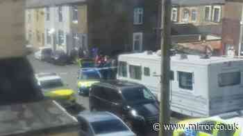Girl, 17, stabbed in the neck in broad daylight as armed police swarm street