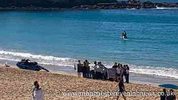 Woman, 30s, attacked by shark while swimming laps at popular beach as witness 'saw the shark's fins'
