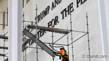 Crews remove Trump name from Kennedy Center after court ruling, weather delay