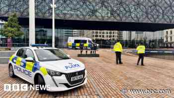 Arrests after two men stabbed outside library