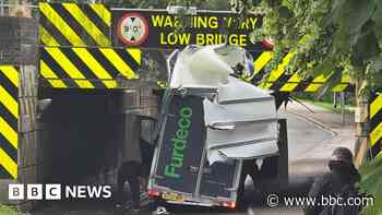 Van loses roof under 'most bashed railway bridge'