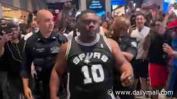 Brave or stupid? San Antonio Spurs fan rescued by NYPD after attempting to fight HUNDREDS of jubilant Knicks fans in the heart of New York