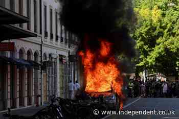G7 protesters smash windows and set Tesla on fire as they march in Geneva