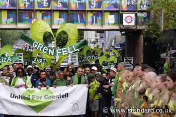 Grenfell demonstrators embrace firefighters during anniversary march