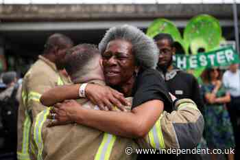 Grenfell survivors embrace firefighters at emotional anniversary march