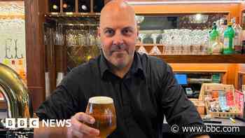 Barman raises a glass after £3.5m house win