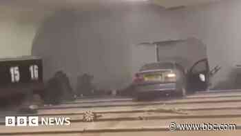 Man charged after car crashes through bowling alley