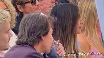 Victoria Beckham receives tender kiss on the hand from pal Tom Cruise as he sits in the middle of their family at David's Walk Of Fame ceremony