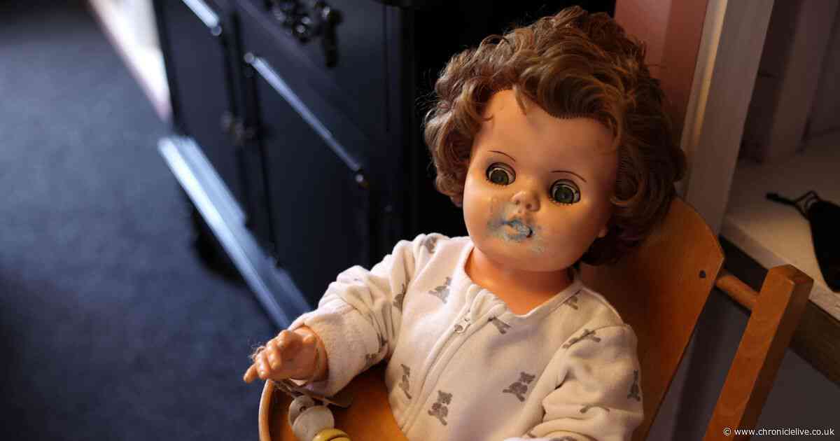Inside Northumberland Haunted Museum with coffin and room filled with dolls
