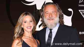 Russell Crowe, 62, shows off his slimmed-down frame as he holds hands with partner Britney Theriot, 42, at the Taormina Film Festival